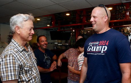 Sinise checks out a Forrest Gump shirt worn by Barrett Smith, Cmdr. of Joint Strike Fighter Wing as NAS Lemoore.